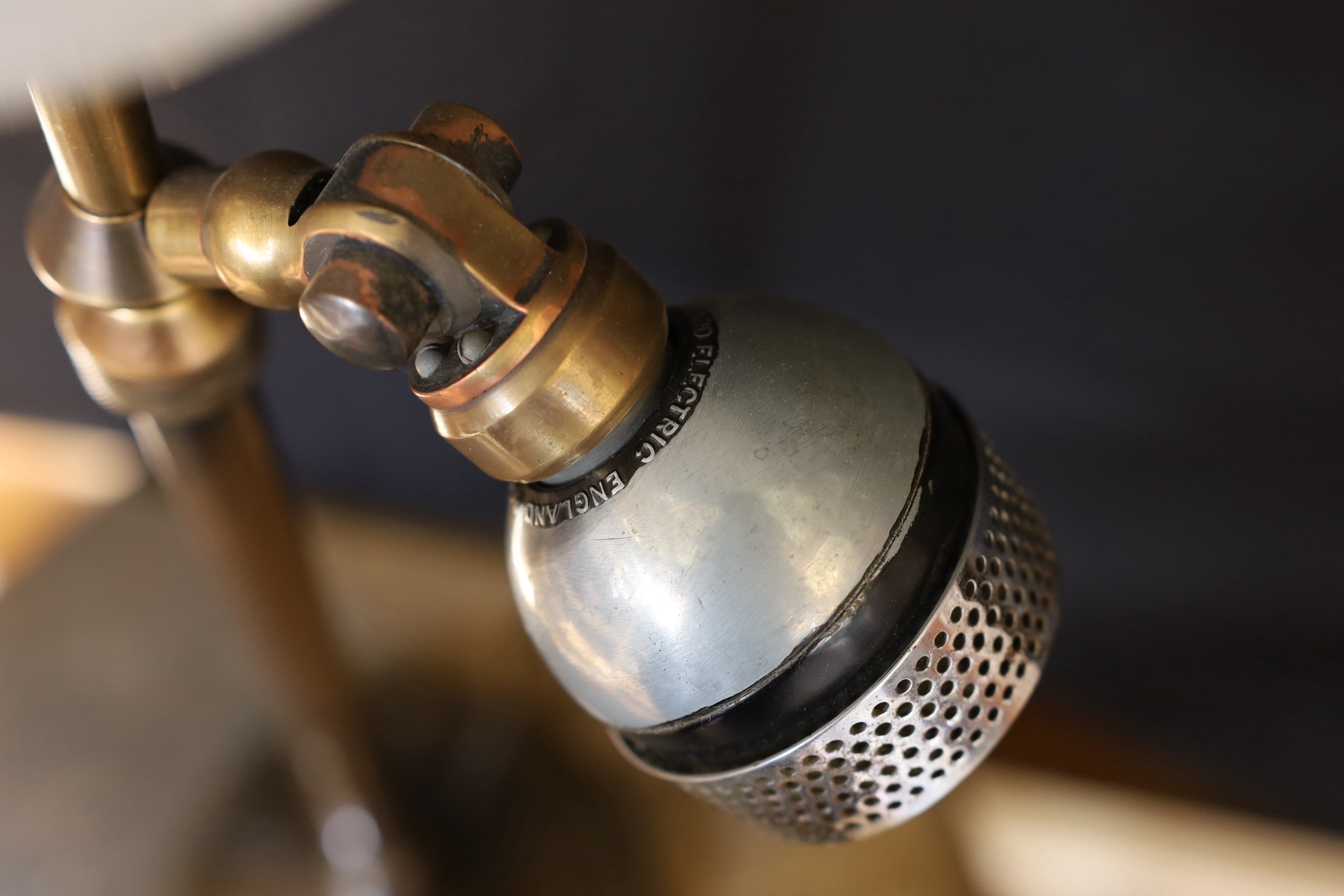 A 1920s BBC microphone converted to a table lamp, with loaded brass base and opaque white glass up lighter shade, height overall 66cm
